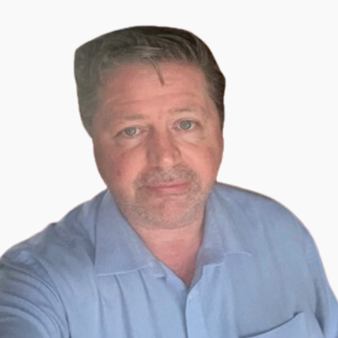 Man wearing light blue shirt smiling slightly