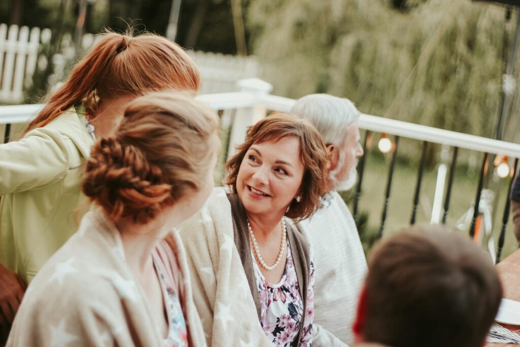 Family enjoying conversation outdoors on a patio