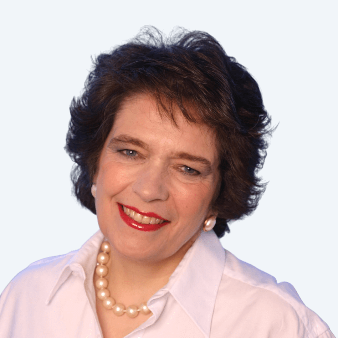 Smiling woman wearing white shirt and pearl necklace