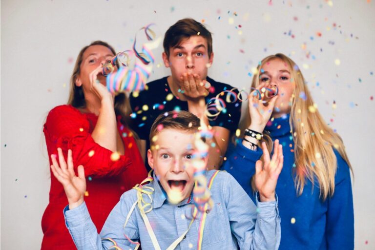 people blowing party favors